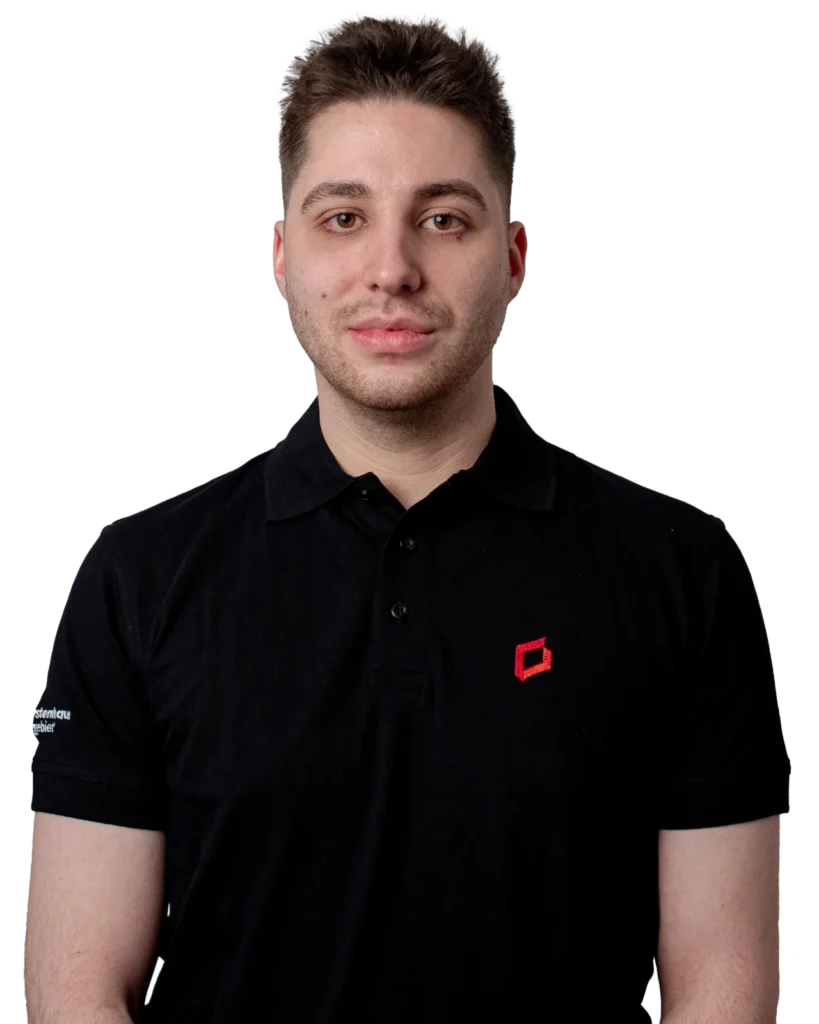 Manuel Severin trägt ein schwarzes Polohemd mit rotem Logo auf der linken Brustseite.